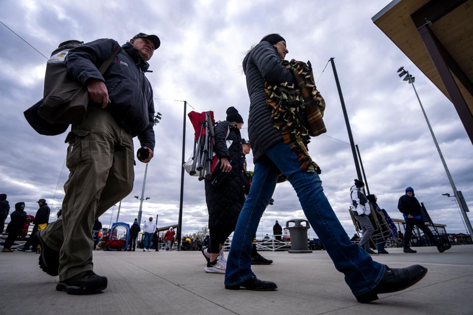 People walk around at GrimesPlex during youth baseball games on April 20.