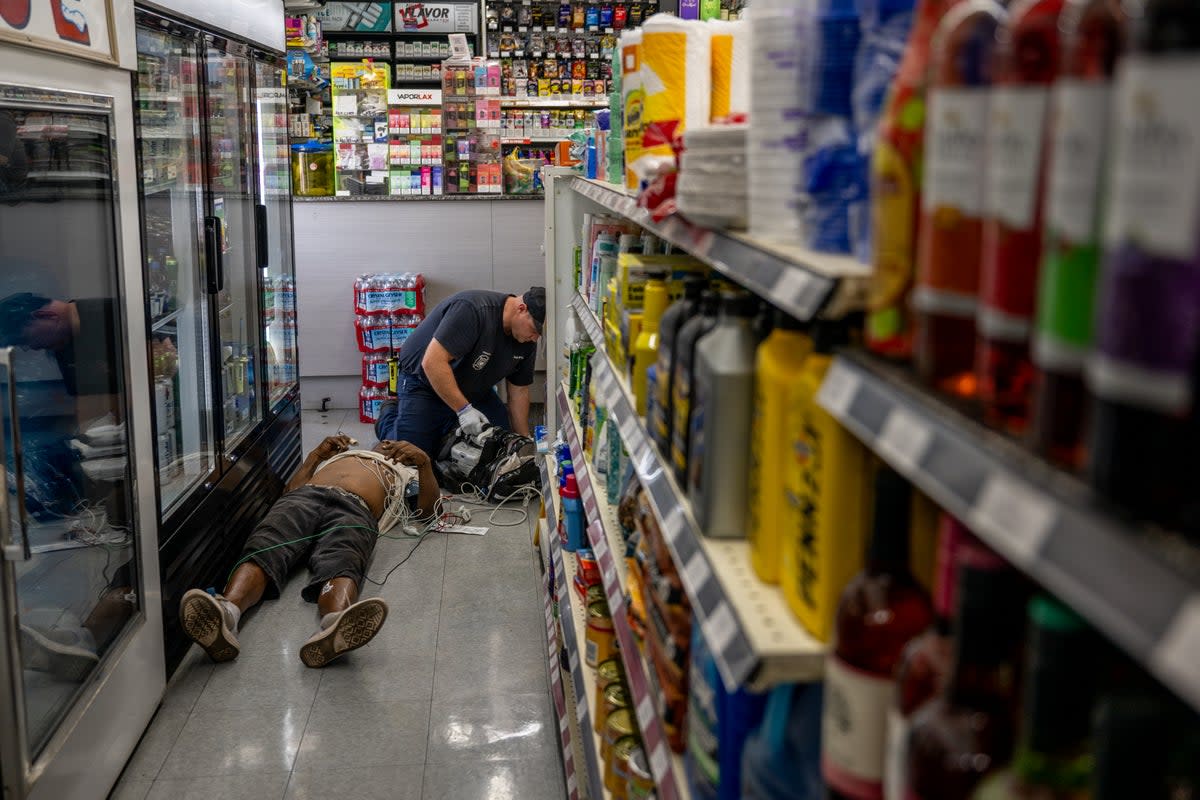 A person receives medical attention after collapsing in a convenience store on July 13, 2023 in Phoenix, Arizona (Getty)