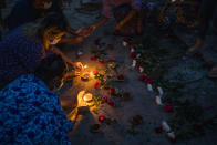 Women light candles during a candlelight vigil to remember those who died during the military junta's violent response to anti-coup demonstrations in Yangon, Myanmar Friday, April 16, 2021. Opponents of Myanmar's ruling junta went on the political offensive Friday, declaring they have formed an interim national unity government with members of Aung San Suu Kyi's ousted cabinet and major ethnic minority groups. (AP Photo)