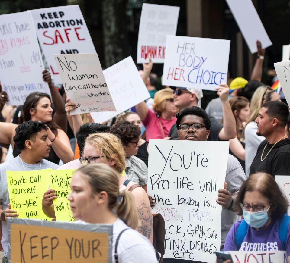 Kleo Young, 19, of Spartanburg holds his sign during Bans Off Our Bodies protest in downtown Greenville, Saturday, June 25, 2022. 