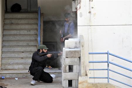 Sunni Muslim fighters fire a weapon inTripoli, northern Lebanon, November 30, 2013. REUTERS/Omar Ibrahim