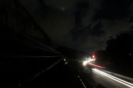 Cars drive through a neighbourhood without electricity after the electrical grid was damaged by Hurricane Maria in September, in Dorado, Puerto Rico January 22, 2018. REUTERS/Alvin Baez