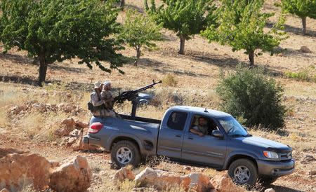 FILE PHOTO: Hezbollah fighters are seen in a truck in Jroud Arsal, near Syria-Lebanon border, August 13, 2017. REUTERS/Ali Hashisho/File Photo