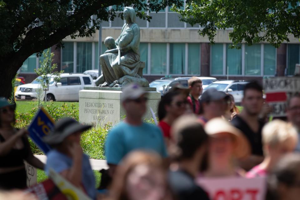 A pioneer women of Kansas statue is seen in the background at an abortion-rights rally Saturday at the Statehouse.