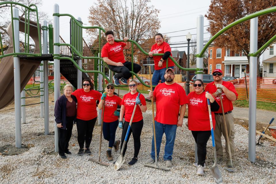 Volunteers from Campbell's Snacks work on a new playground for Wirt Park on Friday in downtown Hanover. The park is a community effort between the YMCA, Campbell's, Rotary Club and Hanover Borough.