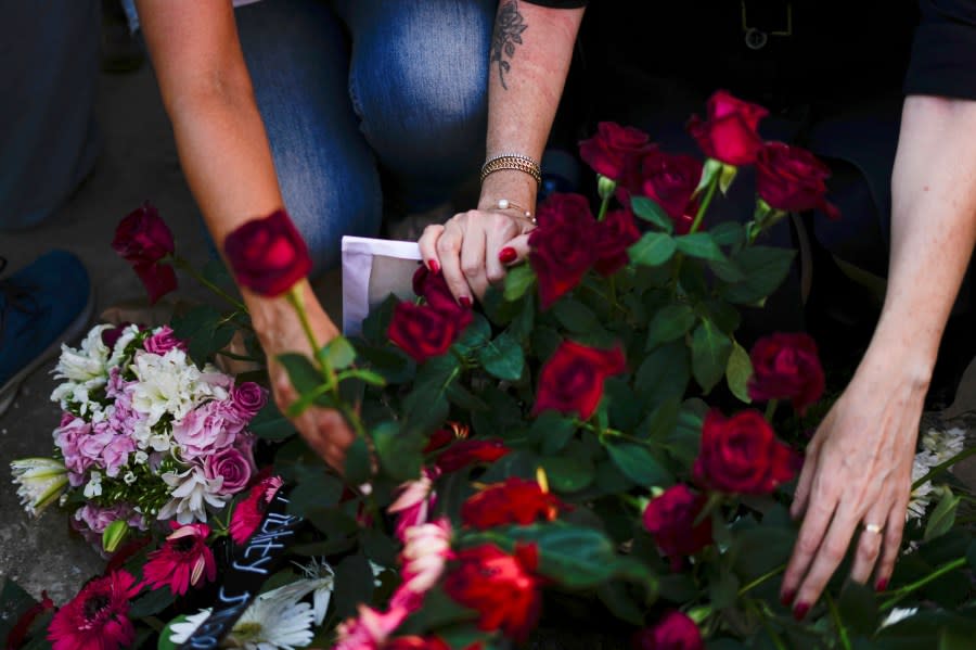 Israelis mourn next to the graves of Danielle Waldmann and her partner Noam Shai, during their funeral in the northern Israeli town of Kiryat Tivon, Thursday, Oct. 12, 2023. (AP Photo/Ariel Schalit)