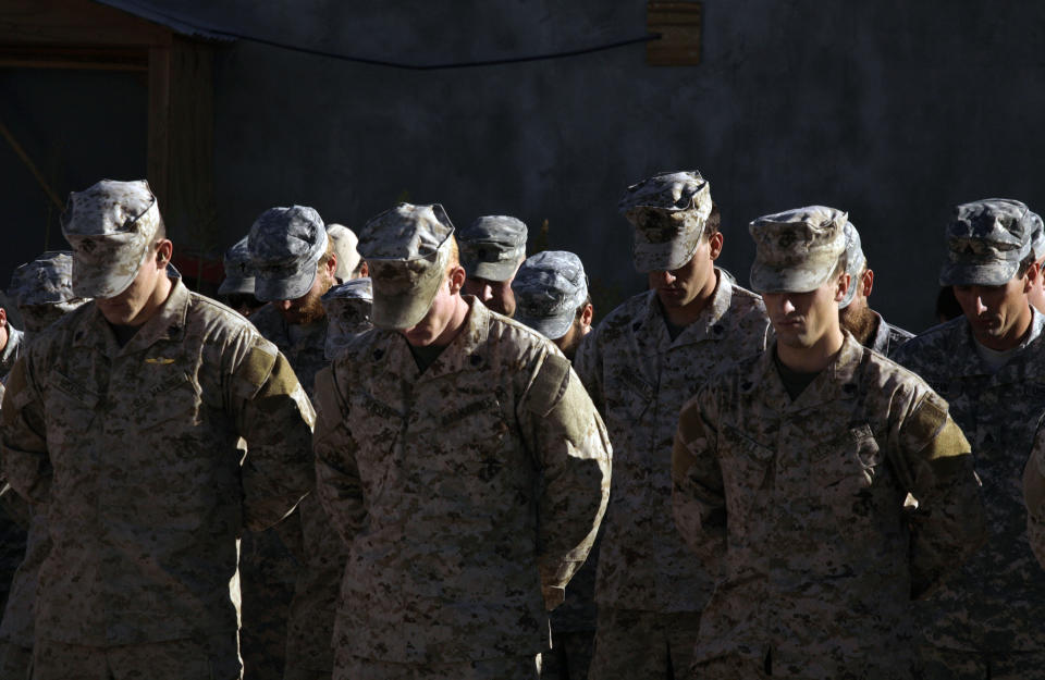 FILE - In this file photo taken Monday, Nov. 9, 2009, U.S. service members are seen during a memorial ceremony for a comrade killed on Saturday in Afghanistan's Farah province. Moscow and Washington are intertwined in a complex and bloody history in Afghanistan, with both suffering thousands of dead and wounded in conflicts lasting for years. Now both superpowers are linked again over Afghanistan, with intelligence reports indicating Russia secretly offered bounties to the Taliban to kill American troops there. But analysts suggest that the two adversaries actually have more in common, especially when it comes to what they want to see in a postwar Afghanistan: a stable country that does not serve as a base for extremists to export terrorism. Both countries also are aligned in their opposition to militants from the Islamic State group. (AP Photo/Maya Alleruzzo, File)