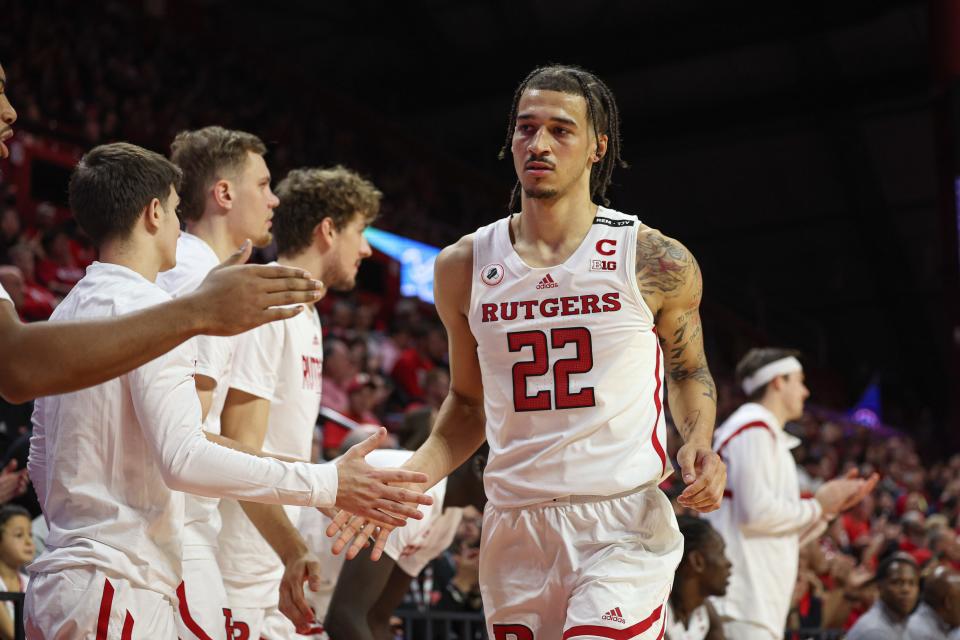 Rutgers Scarlet Knights guard Caleb McConnell (22) slaps hands with teammates after being subbed out during the first half against the Central Connecticut State Blue Devils