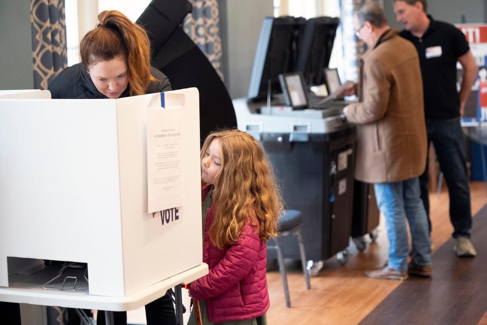 Amanda Hamilton votes while her daughter Hadley Hamilton, 5, watches at the Griswold Center in Worthington on Tuesday.