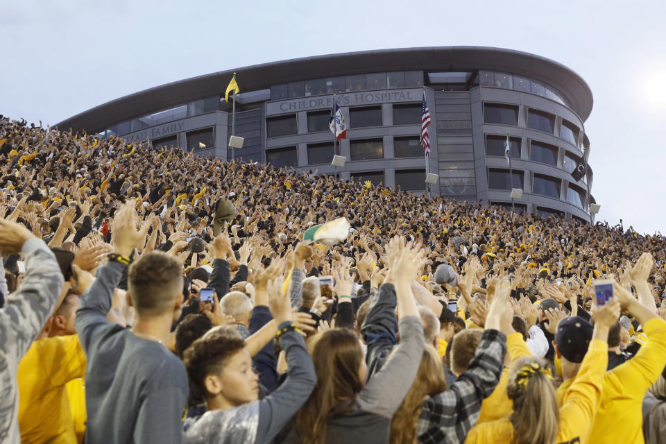 FILE - In this Saturday, Aug. 31, 2019 file photo, Iowa fans wave to children in the University of Iowa Stead Family Children's Hospital at the end of the first quarter of an NCAA college football game between Iowa and Miami of Ohio in Iowa City, Iowa. During a season when the atmosphere will be subdued at Iowa home football games because the usual 69,000 fans won't be there, one tradition will go on uninterrupted. At the end of the first quarter, players and coaches from both teams will turn to the University of Iowa Stead Family Children’s Hospital and wave, just as they've done every home game since 2017.( (AP Photo/Charlie Neibergall, File)