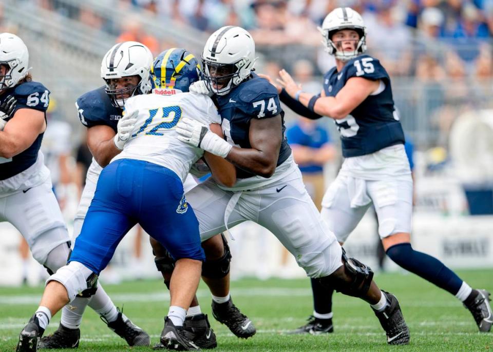 Penn State offensive lineman Olumuyiwa Fashanu blocks Delaware’s Chase McGowan for Drew Allar to make a pass during the game on Saturday, Sept. 9, 2023. 