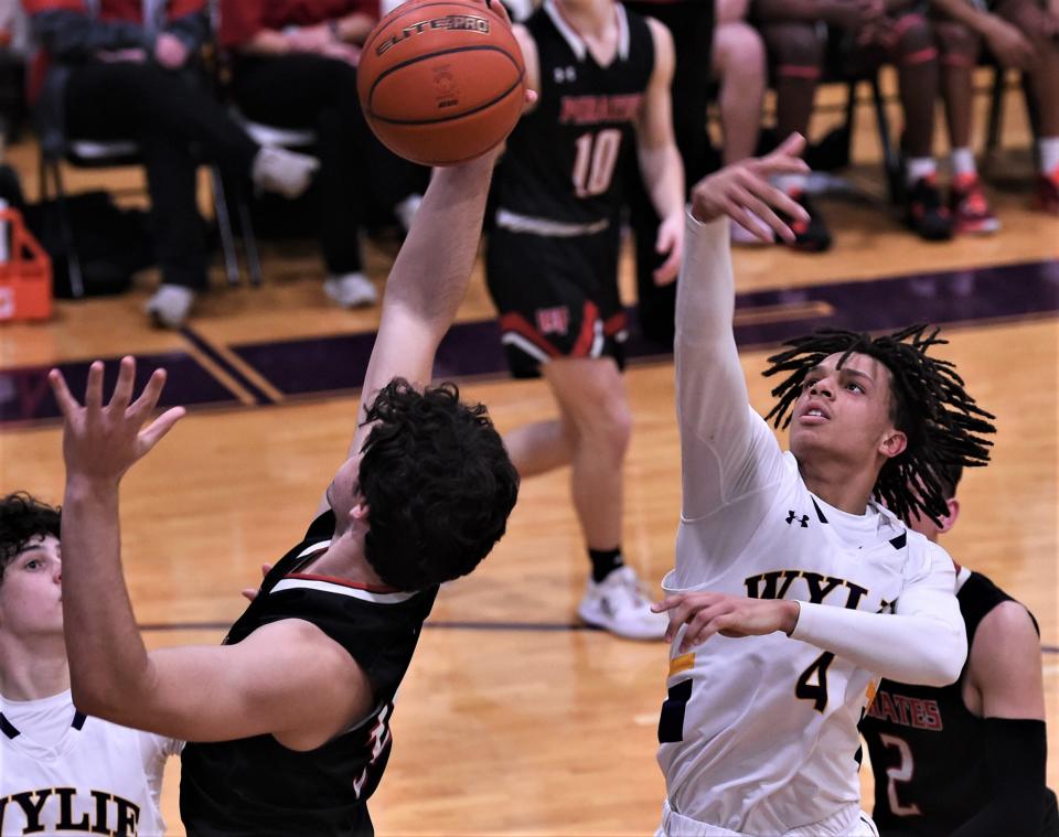 Wylie's Derek Evans (4) battles a Lubbock-Cooper player for a rebound in the second half. Wylie beat the Pirates 75-55 in the District 4-5A game Tuesday, Feb. 7, 2-2023, at Bulldog Gym.
