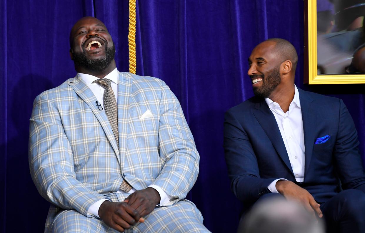 Shaquille O'Neal, left, and Kobe Bryant laugh as they attend the unveiling of a statue of O'Neal in front of Staples Center, Friday, March 24, 2017, in Los Angeles.