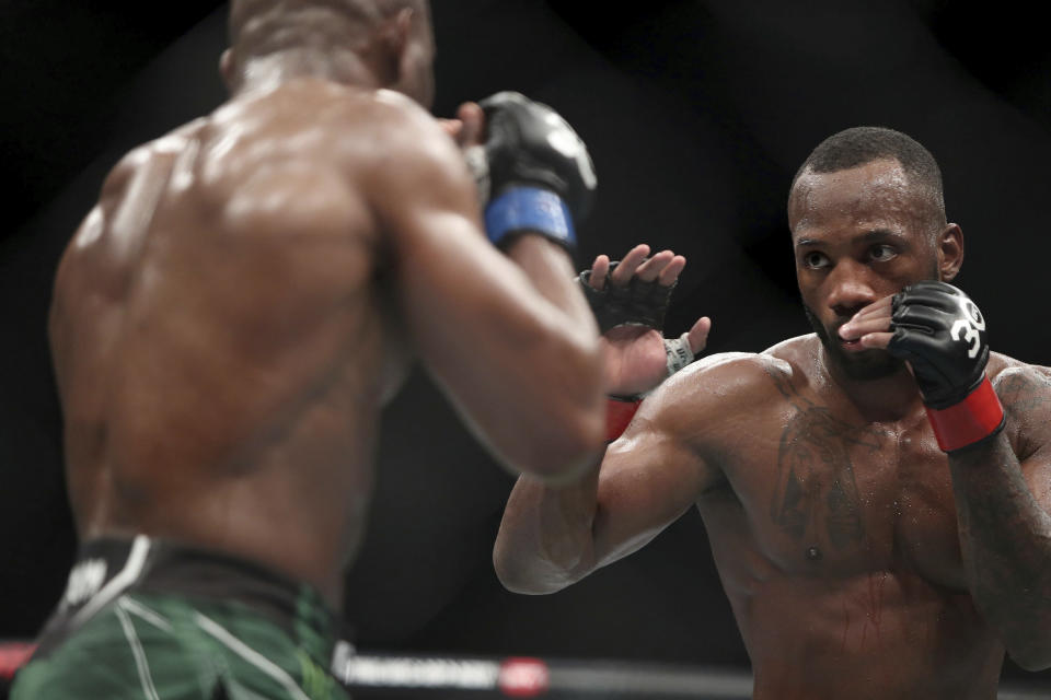 Leon Edwards, right, faces Kamaru Usman during their welterweight title bout at the UFC 286 mixed martial arts event Saturday March 18, 2023, in London. (Kieran Cleeves/PA via AP)