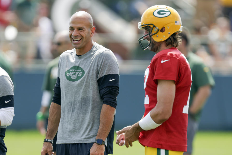 FILE - New York Jets head coach Robert Saleh, center, laughs with Green Bay Packers quarterback Aaron Rodgers, right, during a joint NFL football training camp practice Wednesday, Aug. 18, 2021, in Green Bay, Wis. Rodgers says his intention is to play for the New York Jets in the coming season as the four-time NFL MVP quarterback waits for the Green Bay Packers to trade him. Rodgers made his comments Wednesday, March 15, 2023, during an appearance on “The Pat McAfee Show.” (AP Photo/Matt Ludtke, File)