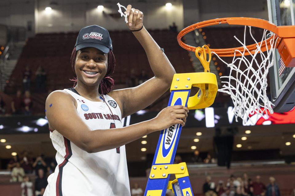 South Carolina's Aliyah Boston (4) holds up her piece of the net defeating Maryland in an Elite 8 college basketball game of the NCAA Tournament in Greenville, S.C., Monday, March 27, 2023. (AP Photo/Mic Smith)