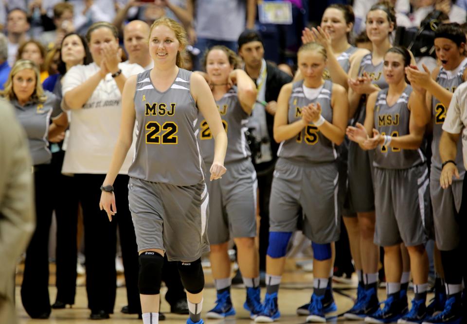 Photo from “Cincinnati: An Illustrated Timeline”: Terminally ill Mount St. Joseph University basketball player Lauren Hill receives applause at her first college game. (The Cincinnati Enquirer/Liz Dufour)