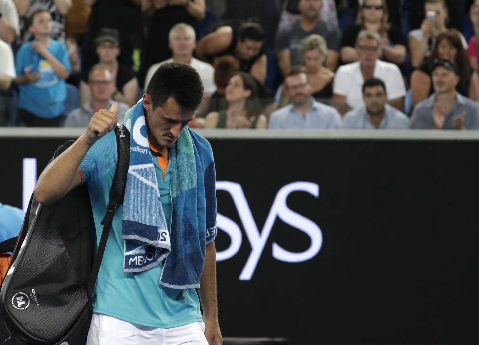 Australia's Bernard Tomic gestures as he leaves the court following his first round loss to Croatia's Marin Cilic at the Australian Open tennis championships in Melbourne, Australia, Monday, Jan. 14, 2019. (AP Photo/Kin Cheung)