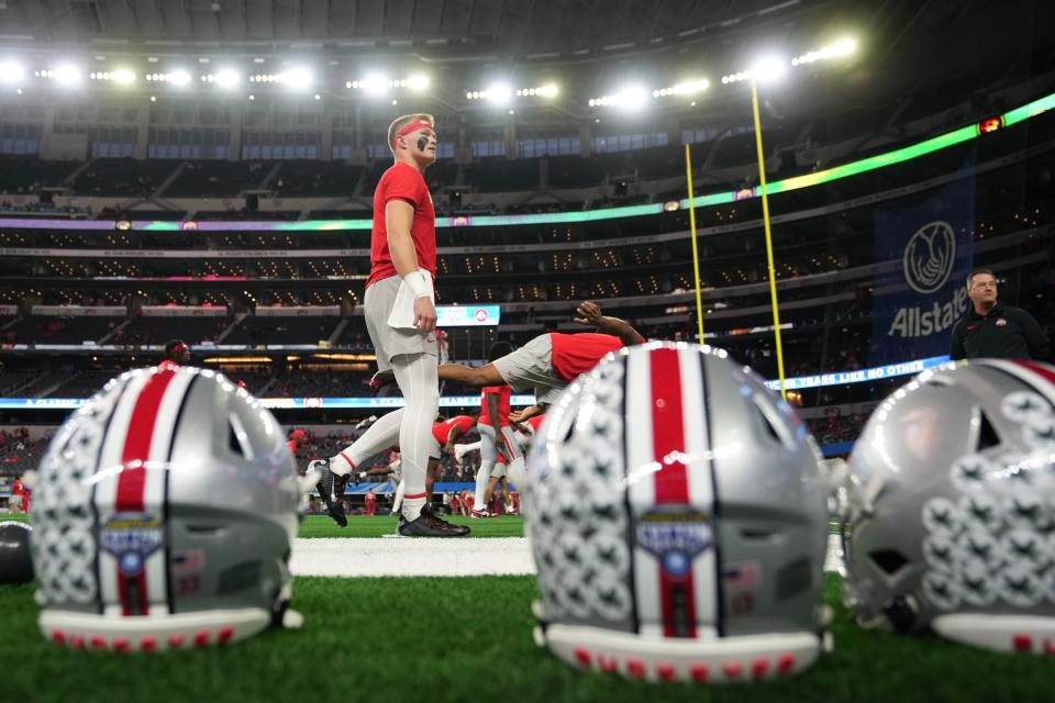 Dec 29, 2023; Arlington, Texas, USA; Ohio State Buckeyes quarterback Lincoln Kienholz (12) warms up prior to the Goodyear Cotton Bowl Classic against the Missouri Tigers at AT&T Stadium.