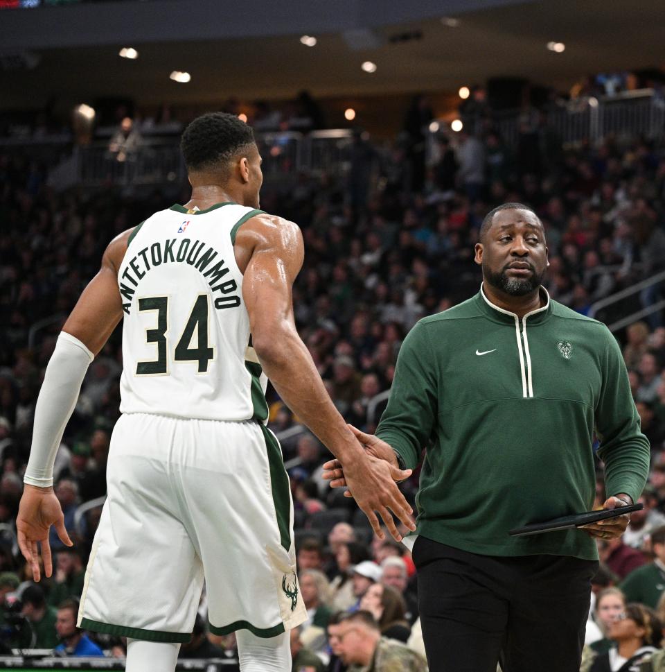 Adrian Griffin greets Bucks forward Giannis Antetokounmpo during a time out in the first half at Fiserv Forum. Antetokounmpo wants to absorb some of the managerial and leadership challenges facing his head coach.