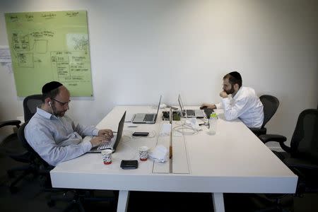 People work at Citi's tech hub in Tel Aviv, Israel December 14, 2015. REUTERS/Amir Cohen