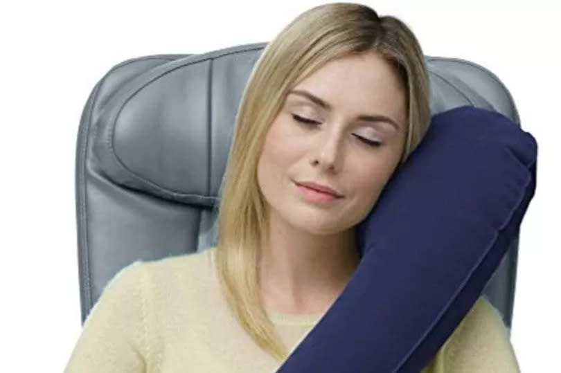 Woman demonstrating a neck pillow