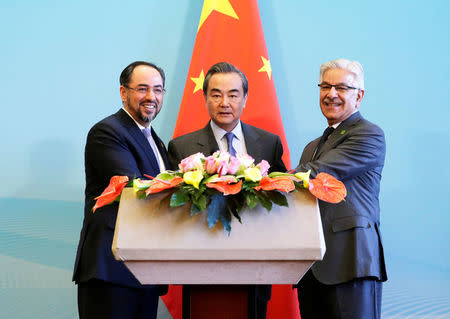 (L to R) Afghan Foreign Minister Salahuddin Rabbani, Chinese Foreign Minister Wang Yi and Pakistani Foreign Minister Khawaja Asif attend a joint news conference after the 1st China-Afghanistan-Pakistan Foreign Ministers' Dialogue in Beijing, China, December 26, 2017. REUTERS/Jason Lee