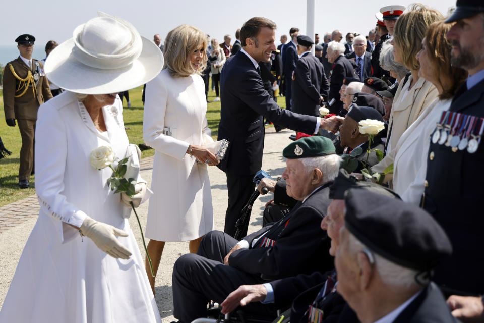 Britain's Queen Camilla, left, French President's wife Brigitte Macron, French President Emmanuel Macron meet with British D-Day veterans during a commemorative ceremony marking the 80th anniversary of the World War II D-Day Allied landings in Normandy, at the World War II British Normandy Memorial of Ver-sur-Mer, Thursday, June 6, 2024. Normandy is hosting various events to officially commemorate the 80th anniversary of the D-Day landings that took place on June 6, 1944. (Ludovic Marin/Pool via AP)