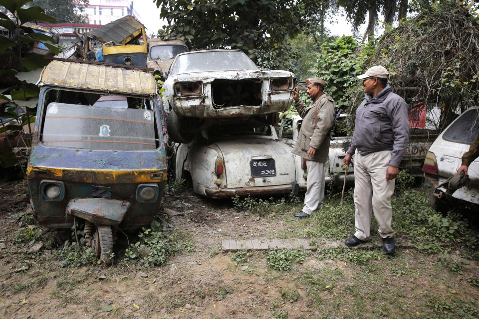 Policemen take an account of accident cars parked at their police station in Allahabad, India, Friday, Jan. 31, 2014. Several of India's most popular car models crumpled in independent crash tests in ways that would likely lead to fatality or serious injury, a global car safety watchdog said Friday. The results are an indictment of the auto industry in India, which lacks adequate safety standards, said David Ward, head of the London car-safety watchdog Global NCAP, which performed the crash tests. India has some of the deadliest roads in the world. (AP Photo/Rajesh Kumar Singh)