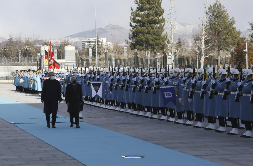 Turkish President Recep Tayyip Erdogan, left, and Germany's Chancellor Olaf Scholz review a military honour guard during a ceremony in Ankara, Turkey, Monday, March 14, 2022. Scholz is visiting Turkey Monday in his first official trip to the country since he took office in December. He will hold talks with Turkish President Recep Tayyip Erdogan in Ankara.(AP Photo/Burhan Ozbilici)