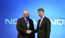 Microsoft Chief Executive Steve Ballmer shakes hands with Nokia's Chairman of the Board Risto Siilasmaa (R) during a Nokia news conference in Espoo September 3, 2013. REUTERS/Lehtikuva
