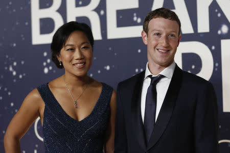 Mark Zuckerberg (R), founder and CEO of Facebook, and wife Priscilla Chan arrive on the red carpet during the 2nd annual Breakthrough Prize Award in Mountain View, California in this November 9, 2014 file photo. REUTERS/Stephen Lam