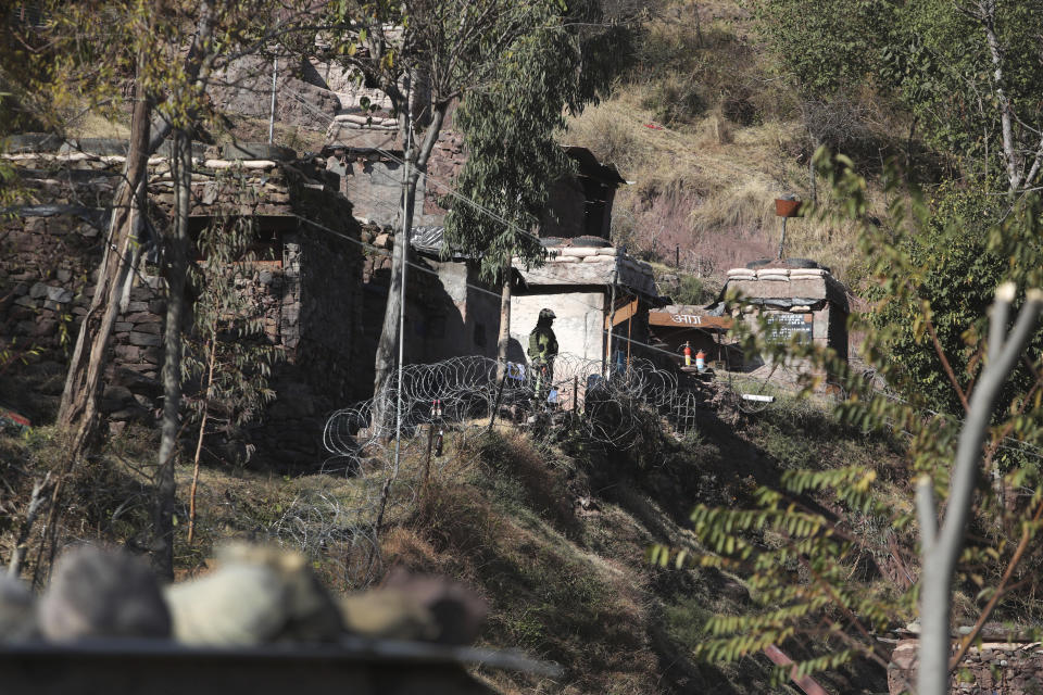An Indian army soldier stands near a forward post at the Line of Control (LOC) that divides the region between the two nuclear-armed rivals of India and Pakistan, in Poonch, about 248 kilometers (155 miles) from Jammu, India, Wednesday, Dec. 16, 2020. Tens of thousands of soldiers from India and Pakistan are positioned along the two sides. The apparent calm is often broken by the boom of blazing guns, with each side accusing the other of initiating the firing. (AP Photo/Channi Anand)