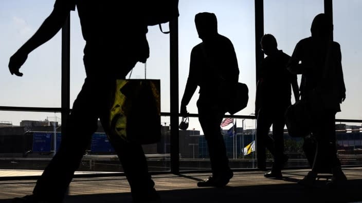 Arriving passengers move toward the baggage claim area at Philadelphia International Airport in Philadelphia in July. Travelers will probably pay more for airline tickets or a hotel room around the holidays than they did over last Thanksgiving or Christmas. (Photo: Matt Rourke/AP, File)