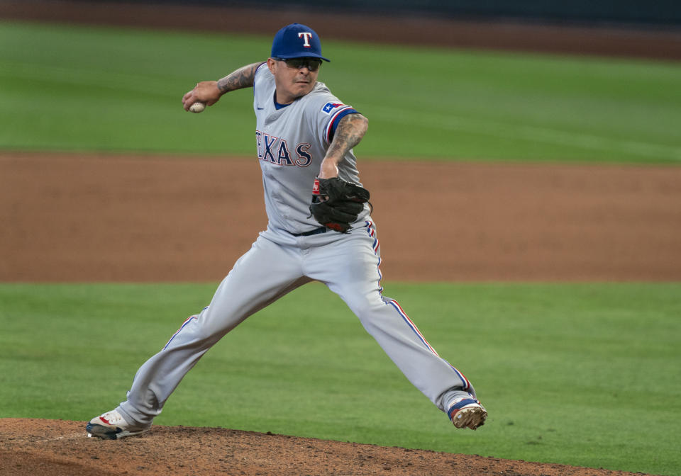 FILE - Texas Rangers reliever Jesse Chavez delivers a pitch during a baseball game against the Seattle Mariners in Seattle, in this Monday, Sept. 7, 2020, file photo. Veteran right-hander Jesse Chavez has re-signed with the Los Angeles Angels on a minor league deal. Chavez will join the Angels’ spring training camp in Tempe, Arizona, after he clears their intake protocols. Chavez appeared in 38 games for the Angels in 2017. (AP Photo/Stephen Brashear, File)