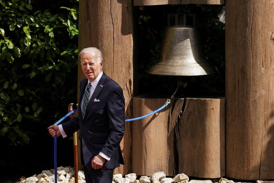 Biden rings the Peace Bell, during a meeting with Irish president Michael Higgins, at Aras an Uachtarain in Dublin (Reuters)