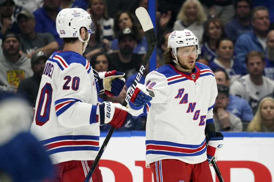 New York Rangers left wing Artemi Panarin (10) celebrates his goal against the Tampa Bay Lightning with left wing Chris Kreider (20) during the third period in Game 4 of the NHL hockey Stanley Cup playoffs Eastern Conference finals Tuesday, June 7, 2022, in Tampa, Fla. (AP Photo/Chris O'Meara)