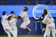 Japan's Takuya Kai, center, and teammates celebrates their wins after a baseball game against the United States at the 2020 Summer Olympics, Monday, Aug. 2, 2021, in Yokohama, Japan. Japan won 7-6. (AP Photo/Sue Ogrocki)