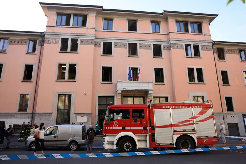 Firefighters work at the scene following a fire in a retirement home in Milan