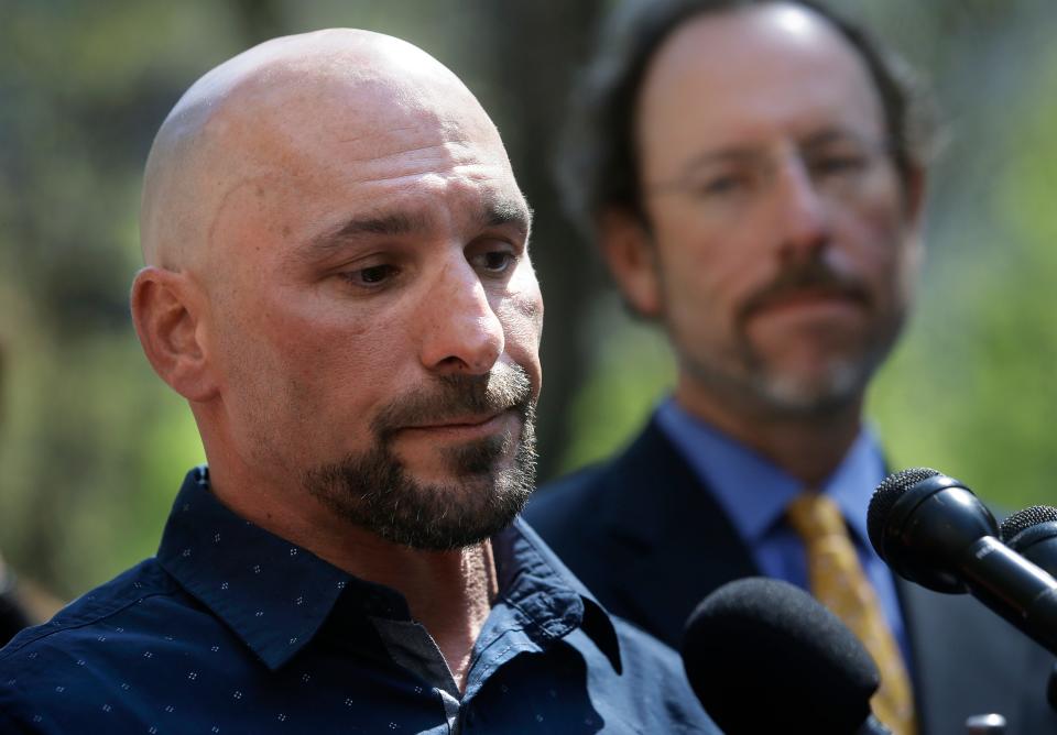 Natale "Nat" Cosenza, who spent 16 years in prison for a crime he says he didn't commit, faces reporters as attorney Chauncey Wood, right, looks on during a news conference May 10, 2018, in Boston.