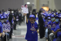 A supporter holds a cut-out of Thailand's Prime Minister Prayuth Chan-ocha as he officially announces joining the United Thai Nation Party as a newly-established party's candidate in Bangkok, Thailand, Monday, Jan. 9, 2023. Prayuth, who first came to power as army chief leading a coup in 2014, became prime minister in an elected government in 2019 as the candidate of the military-backed Palang Pracharath Party, but has split with his former colleagues to become the candidate for Ruam Thai Sang Chart, or United Thai Nation Party, in this year's not-yet-scheduled general election. (AP Photo/Sakchai Lalit)