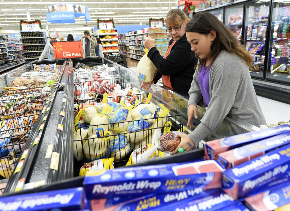Tina Corpus and her daughter Christina, 13, shop for turkey at a Walmart store in the Porter Ranch section of Los Angeles November 26, 2013. This year, Black Friday starts earlier than ever, with some retailers, including Wal-Mart, opening early on Thanksgiving evening. About 140 million people were expected to shop over the four-day weekend, according to the National Retail Federation. REUTERS/Kevork Djansezian  (UNITED STATES - Tags: BUSINESS FOOD)