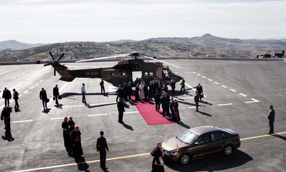 Pope Francis disembarks from a Jordanian military helicopter as he arrives to the West Bank town of Bethlehem