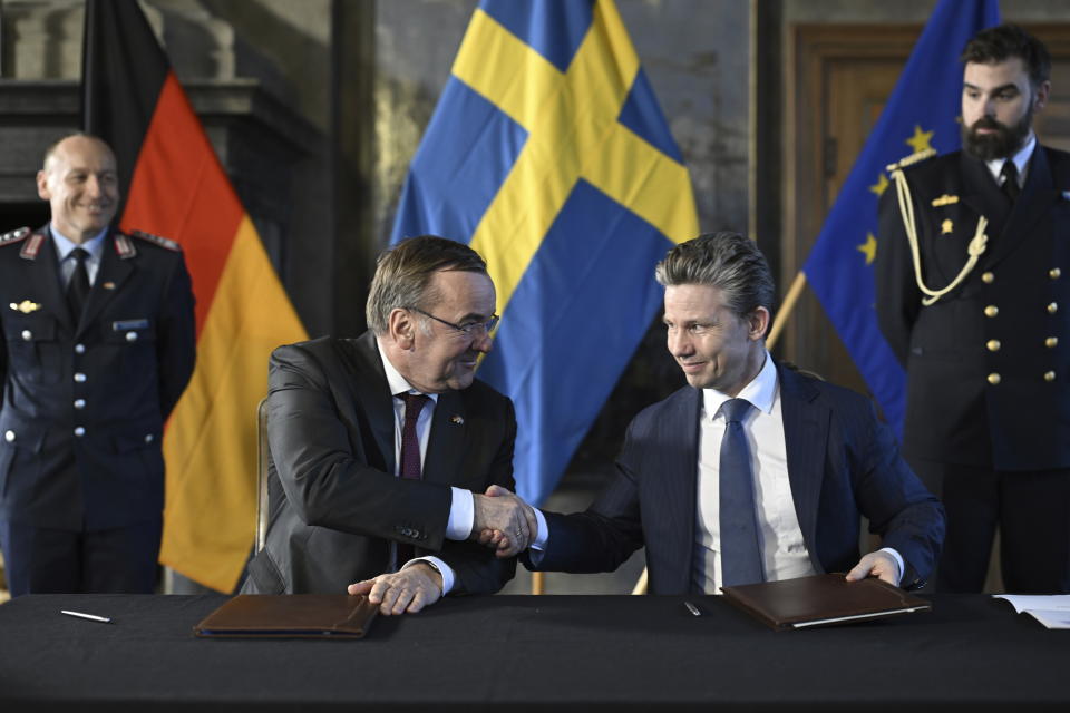 German Defense Minister Boris Pistorius, centre left, and Swedish Defense Minister Pål Jonson shake hands during their meeting at Karlberg Palace in Solna, Stockholm, Tuesday, March 5, 2024. (Pontus Lundahl/TT News Agency via AP)