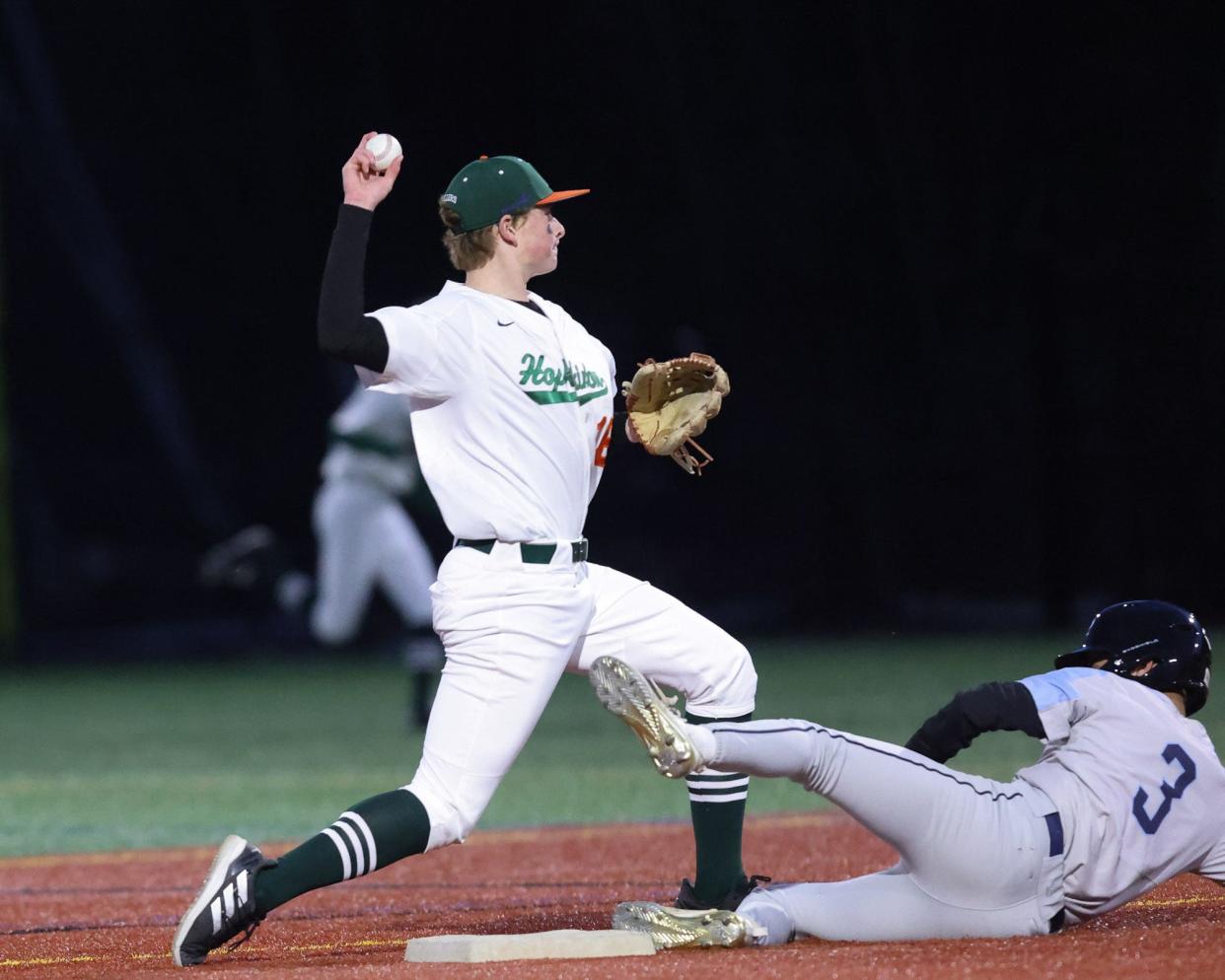 Hopkinton’s Derek Hatherley makes the play at second base during the Hillers' baseball game against Medfield at Hopkinton High School on April 4, 2023.