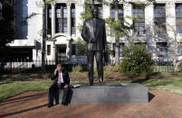 FILE - House Majority Leader H. Morgan Griffith, R-Salem, talks on a phone as he sits at the feet of the statue of former Gov. and U.S. Sen. Harry F. Byrd at Capitol Square in Richmond, Va. Saturday, March 13, 2010. A panel of Virginia legislators will discuss the removal of a statue of former governor and U.S. Sen. Harry F. Byrd Sr., from the state Capitol grounds. Byrd was a staunch segregationist and the architect of massive resistance against integrating schools. (Bob Brown/Richmond Times-Dispatch via AP)