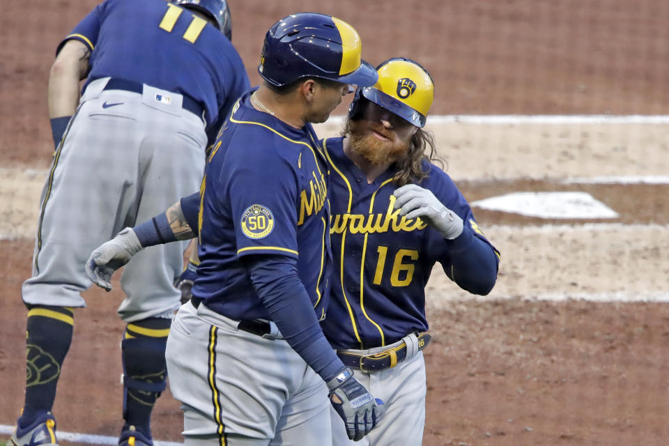 Milwaukee Brewers' Ben Gamel, right, celebrates with Avisail Garcia after hitting a two-run home run off Pittsburgh Pirates starting pitcher Joe Musgrove during the third inning of a baseball game in Pittsburgh, Wednesday, July 29, 2020. (AP Photo/Gene J. Puskar)