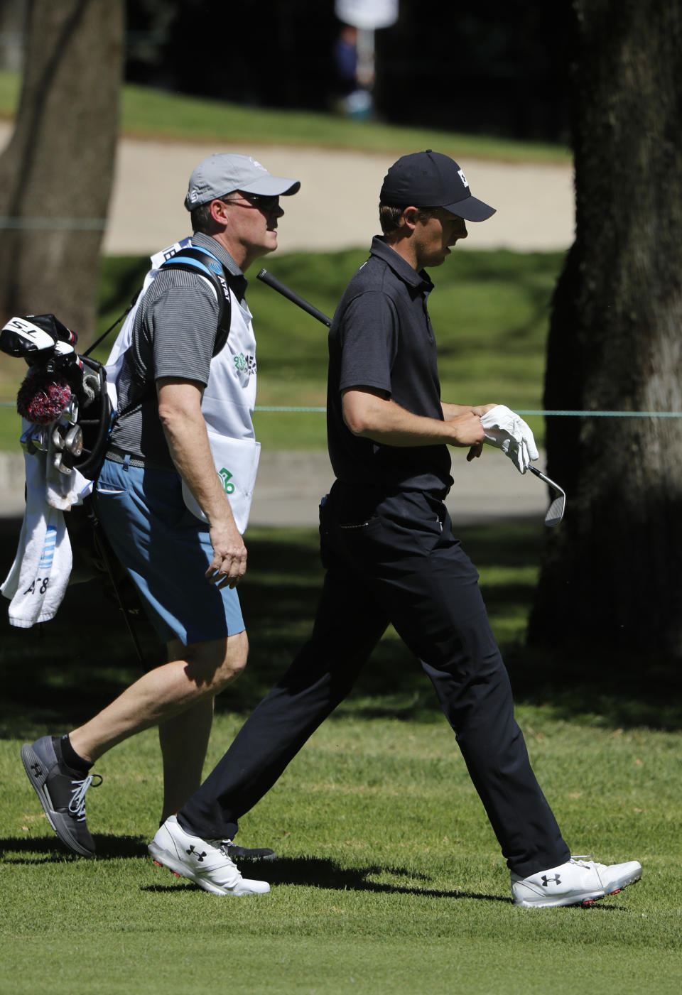 Jordan Spieth, right, walks with his father Shawn Spieth serving as his caddie during the first day of competition of the WGC-Mexico Championship at the Chapultepec Golf Club in Mexico City, Thursday, Feb. 21, 2019. Spieth’s father caddied nine holes of practice Wednesday and will be on the bag the rest of the week after Spieth's caddie left because of the death of his father. (AP Photo/Marco Ugarte)