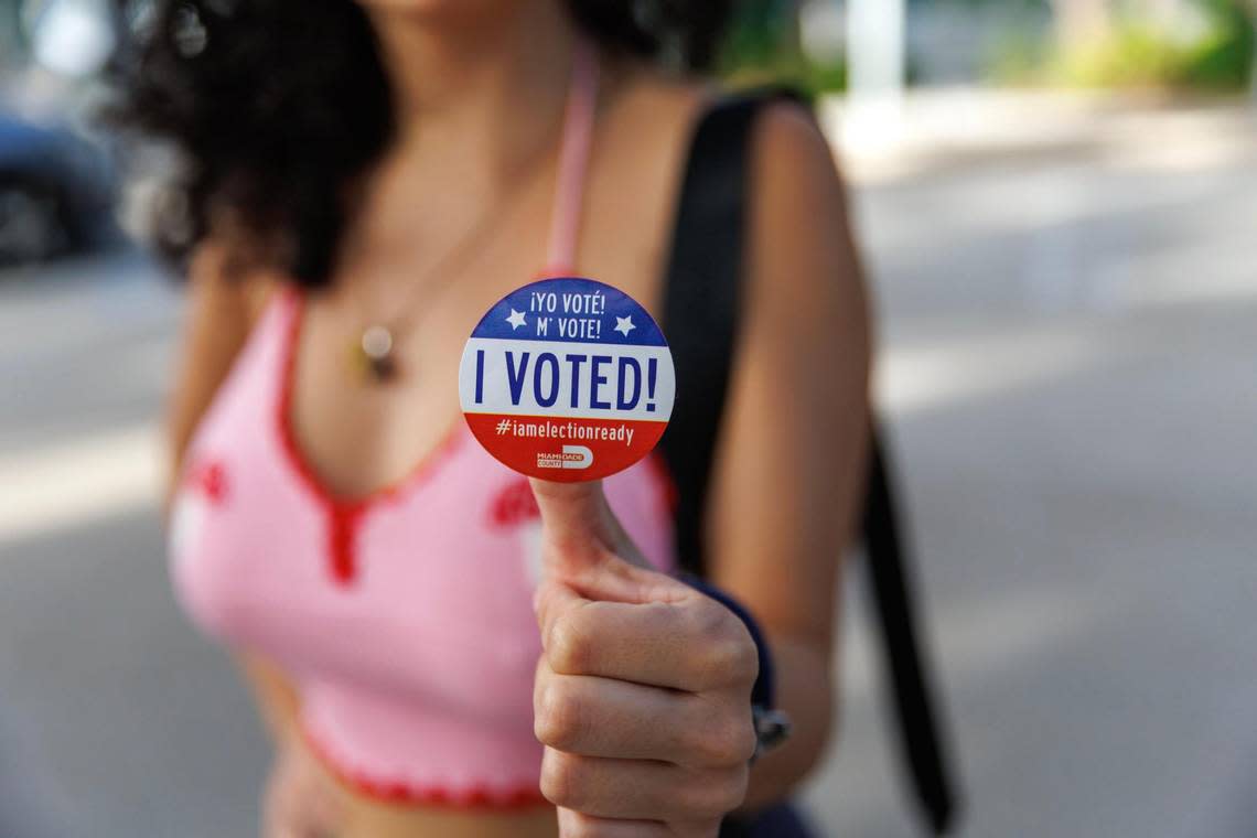 Nicole Montesinos, 23, poses with an “I Voted!” sticker after voting in Miami-Dade County at the Aventura Branch Library on Tuesday, Nov. 8, 2022, in Aventura, Florida.