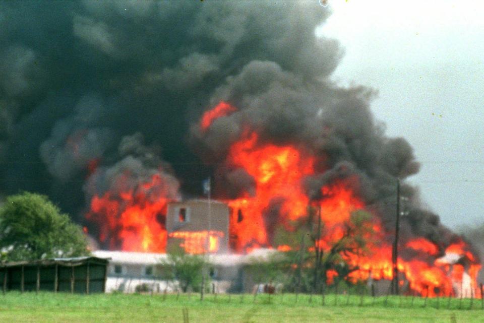 A fire engulfs the Branch Davidian compound near Waco on April 19, 1993. Among the survivors was Clive Doyle, who faced federal murder conspiracy charges with several other members of the sect, but Doyle and two other defendants were acquitted on all counts.